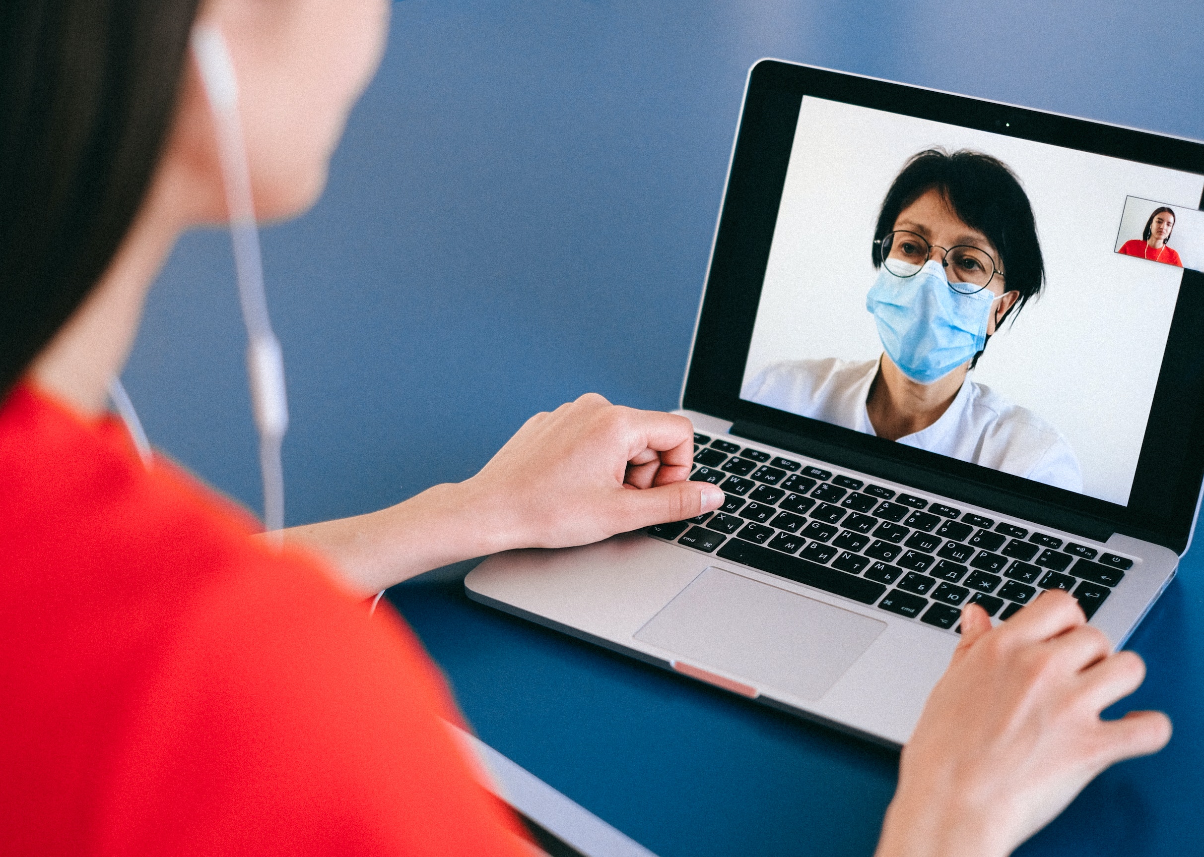 Image of a woman using a laptop to attend a telemedicine video appointment with a virtual doctor.